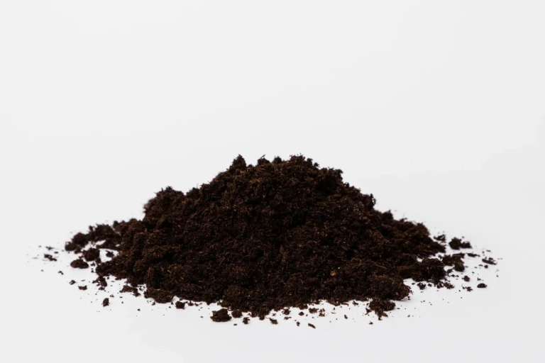 Black Gold NO Peat Moss-PLUS 1 loose dark soil substitute for peat, organic potting amendment pile on white background
