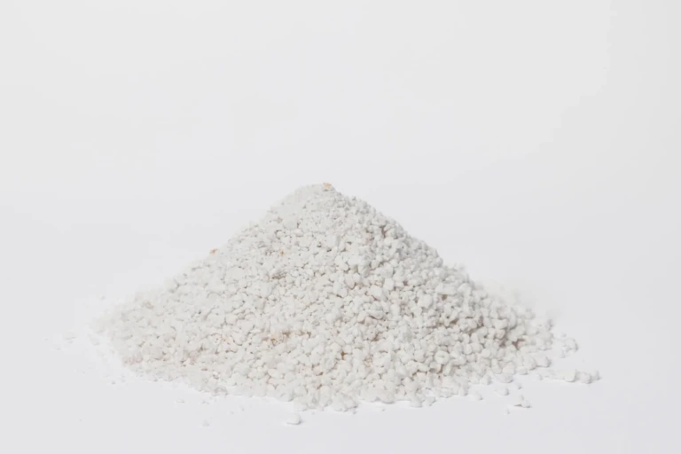 Pile of Black Gold Perlite horticultural white porous aggregate for soil aeration and drainage, close-up on white background