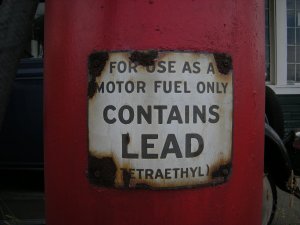 A warning sign on an old leaded gasoline pump